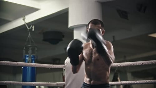 Athletic Man Boxing in Ring Throwing Punches