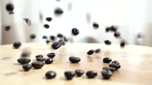 Coffee Beans Falling in Slow Motion on Table
