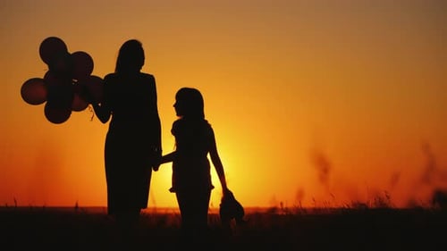 Mom and Daughter Admire the Sunset in a Picturesque Place