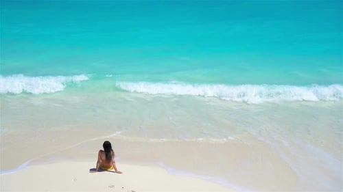 Young Woman on the Beach in Water View Above