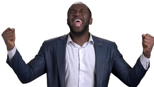 Cheerful Successful African Businessman in Suit Rejoises Success.