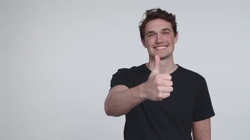 Young Adult Giving Thumbs Up in Studio
