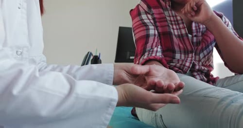 Medical Exam: Doctor Inspecting Patient's Hand