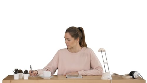 Young Adult Working at a Desk, Using Tablet