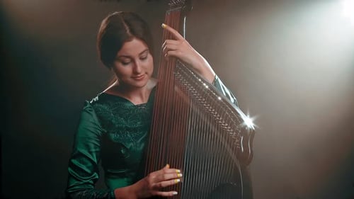 Woman Plays Stringed Musical Instrument in Studio