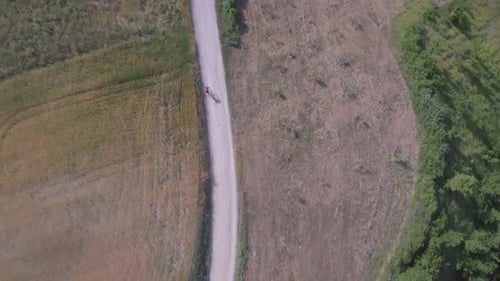 Man cycling with mountain bike on countryside road