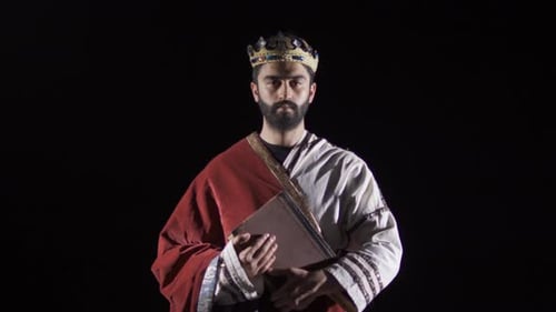 Regal Man Holding a Book in the Darkness