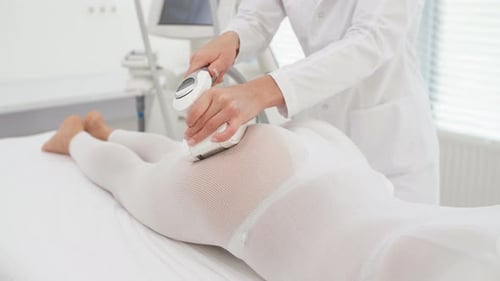 Young Female Therapist Doing Beauty Therapy with LPG Machine in Medical Clinic.