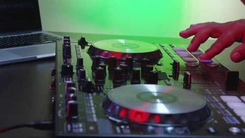 Close Up of DJ Using Sound Mixing Board