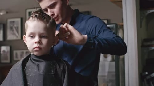 Barber Giving Haircut to a Young Child