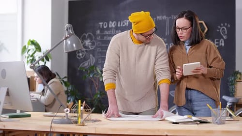 Colleagues Working on Creative Project in Office