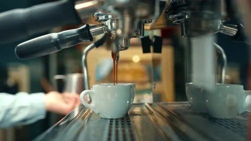 Espresso Machine Pouring Two Coffees in a Cafe