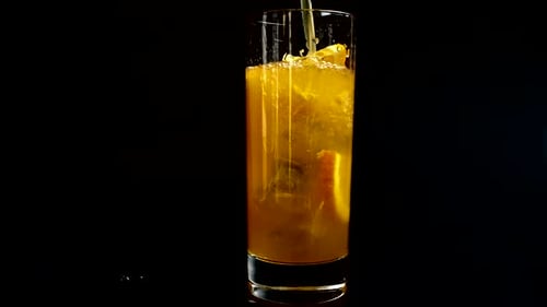 Adding Ice, Orange Slices and Liquid To Glass