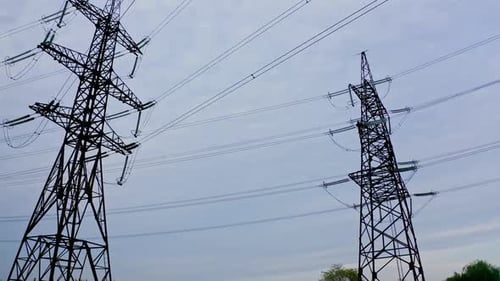Electrical Towers and Power Lines Against Overcast Sky