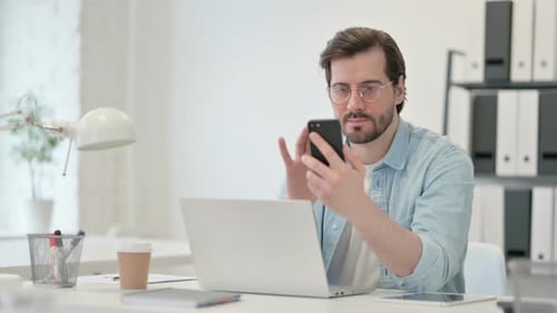 Young Man Laptop Using Smartphone Work