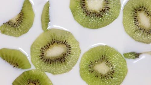 Sliced Kiwi Floating in Fresh White Milk