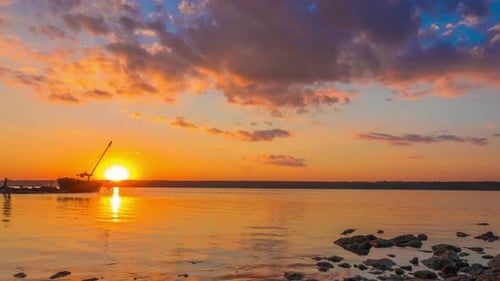 Sunset over the River with Boat in the Background