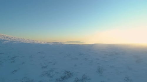 Sunrise Above Snow Covered Mountain Tops in Sunny Winter Day