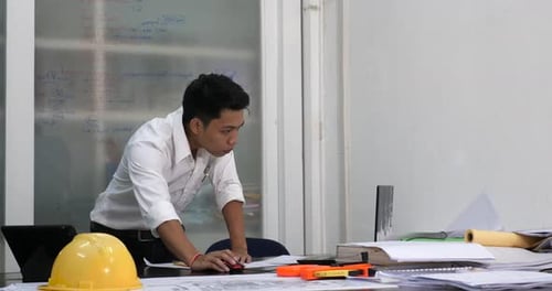 Young Man Draws A Sketch In The Office