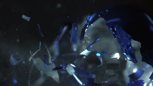 Slow motion of ornament exploding from being shot with air gun.