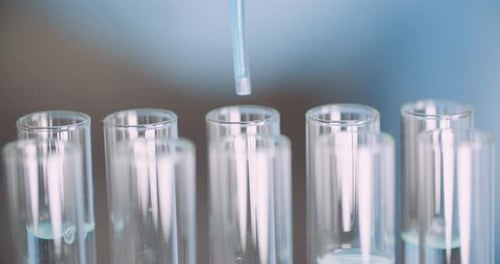 Extreme Close Up of Pipette Dropping Water Into Sample Tube at Laboratory