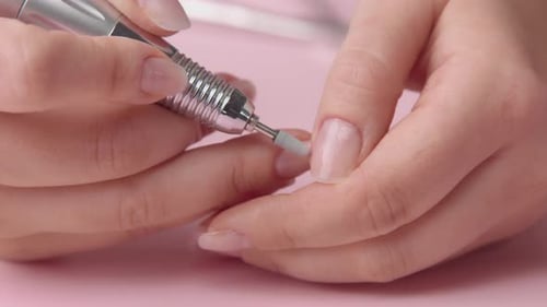 Woman Using Nail Filer for Manicure