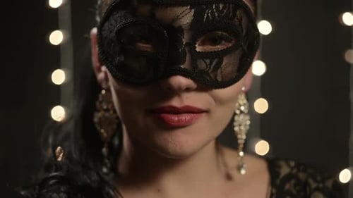 Woman in Masquerade Mask with String Lights