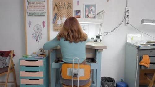 Freelance Jeweler Holding A Tool Inside Her Workshop