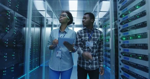 IT Professionals Inspect Servers in Data Center
