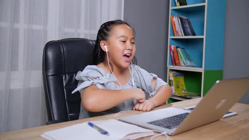 Child Uses Laptop for Online Learning at Home
