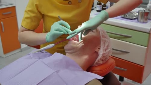 Dentist Performing Dental Procedure in Bright Office