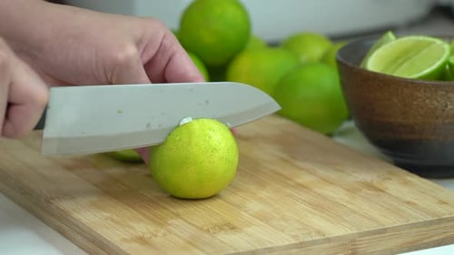 Cutting Lime into Wedges on Wooden Cutting Board