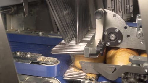 Machine Slicing Bread on Automated Assembly Line
