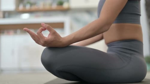 Woman Practicing Yoga in Lotus Position Indoors