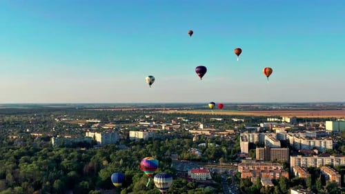 Colorful Hot Air Balloons Floating Over City