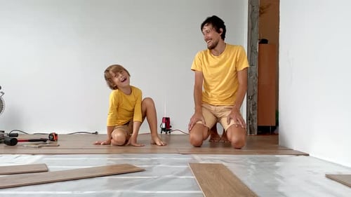 Father and Child Laying Wooden Floor Together