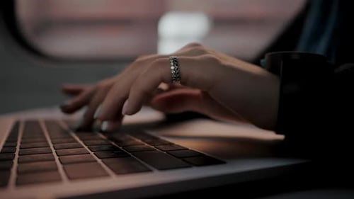 Woman's Hands Typing on Laptop Keyboard