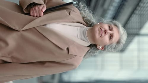 Stylish Senior Woman Walking in Urban Environment