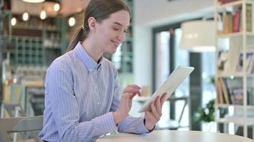 Digital Tablet Use By Beautiful Young Businesswoman in Cafe