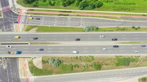 Aerial view of a freeway intersection. Clip. Highway and overpass with cars and trucks, interchange,