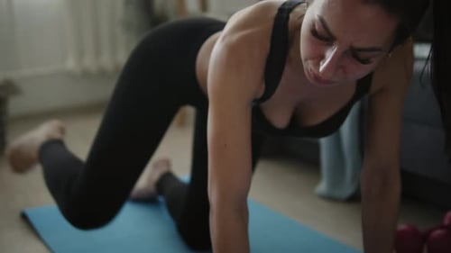 Woman Exercising Glutes on Yoga Mat at Home