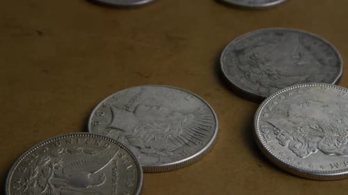 Vintage Silver Coins Close Up on Brown Surface