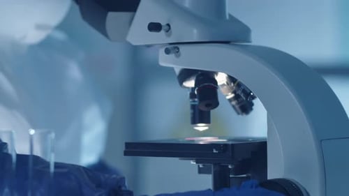 Scientist Uses Microscope in a Cool Blue Lab
