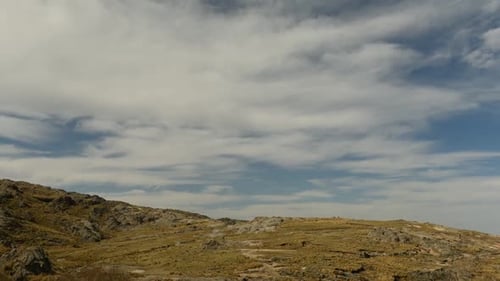 Rocky Hill Landscape with Cloudy Blue Sky