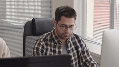 Young Adults Working Hard in Modern Office