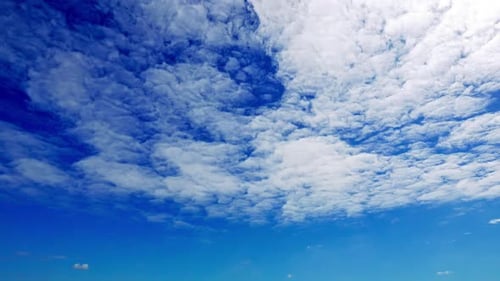 Fluffy White Clouds Flowing in a Blue Sky