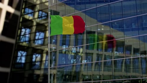 Mali National Flag Waving in Front of Modern Building