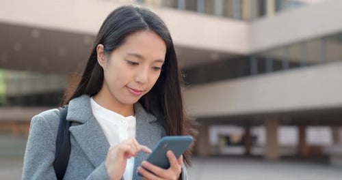 Young Businesswoman use of smart phone in city