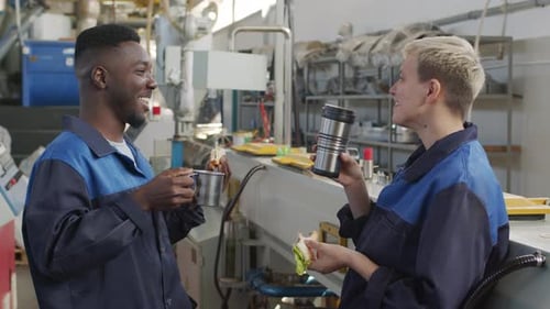 Cheerful Factory Workers Enjoying Lunch Break