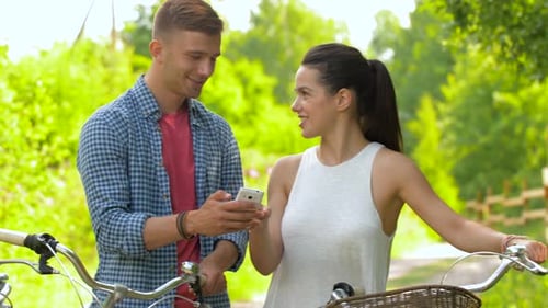 Friends with Bicycles and Smartphones at Park